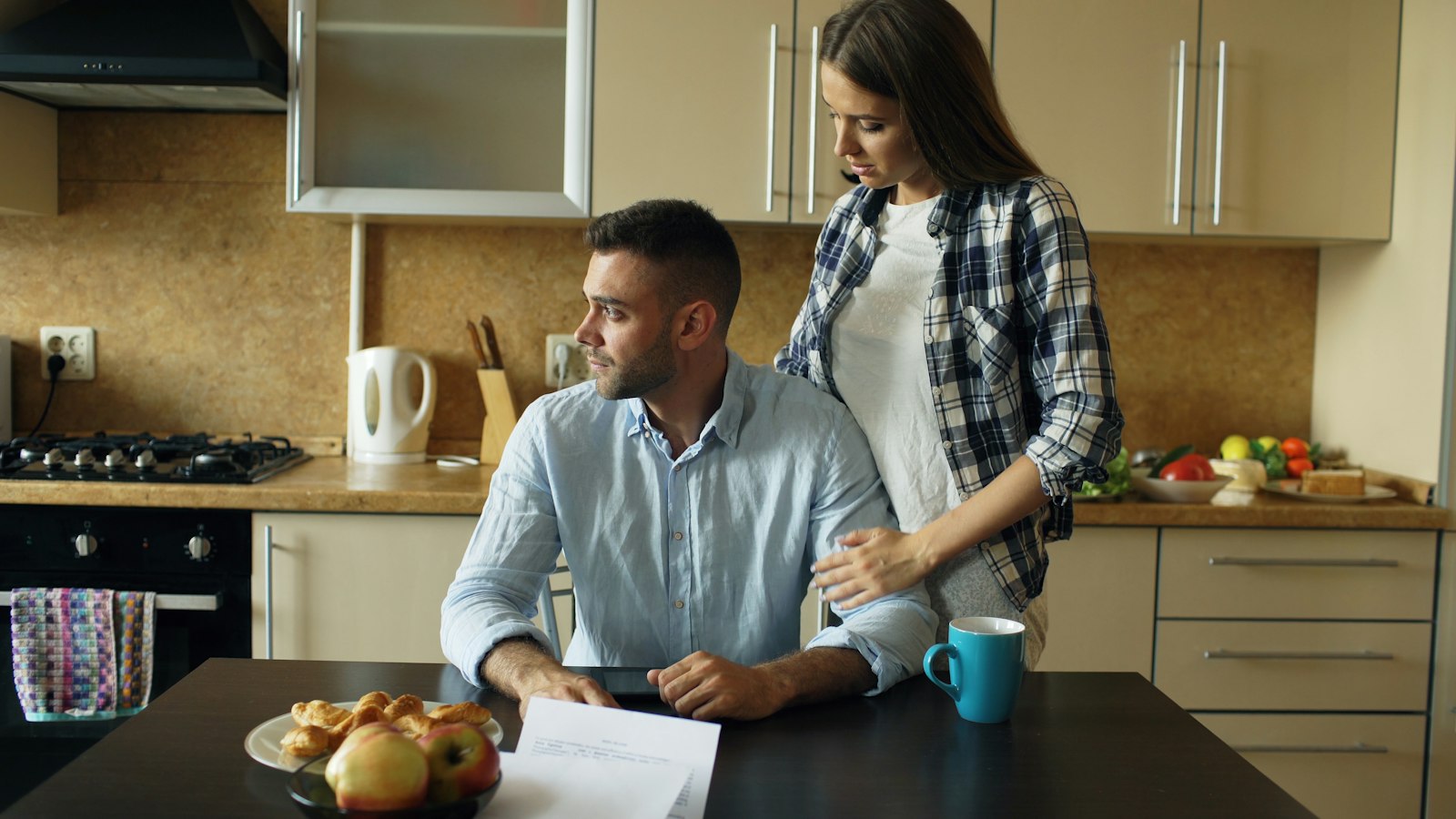 A couple sitting together at a kitchen table