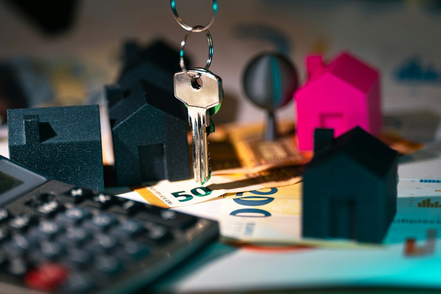 A calculator, keys and a model house